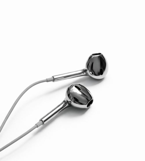 A pair of glossy chrome silver wired earbuds with a light gray cable, shown on a clean white background.